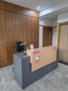 an office cubicle with a desk and a chair at Barza Inn in Kakkanad
