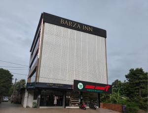 a large building with a sign on it at Barza Inn in Kakkanad