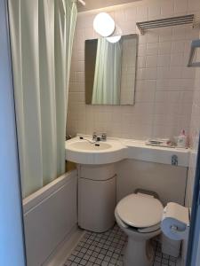 a bathroom with a sink and a toilet and a mirror at ACE INN Itabashi in Tokyo +27 photos