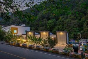 a house with lights on the side of a street at Hadong Cloud Hill Pension in Hadong