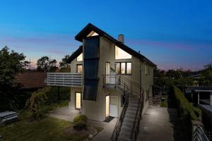 a house with a spiral staircase in front of it at Green House Copenhagen in Copenhagen