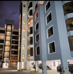 a large white building with many windows at Lakeview 3BR Apartment Nakuru CBD in Nakuru