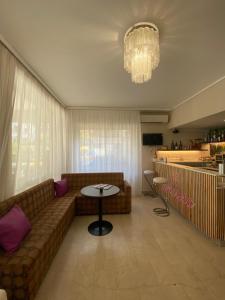 a living room with a couch and a table at Hotel Cimarosa in Riccione