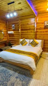 a large bed in a room with wooden walls at كوخ الوهط الريفي in Taif +45 photos