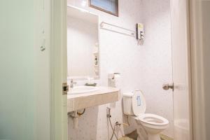 a bathroom with a toilet and a sink and a mirror at The Houme - Fisherman Village in Bophut +102 photos
