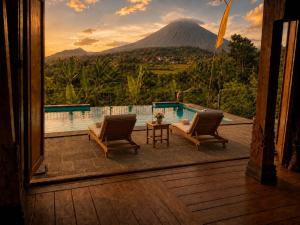 a view of a pool with a mountain in the background at Villa Hola Agung in Karangasem