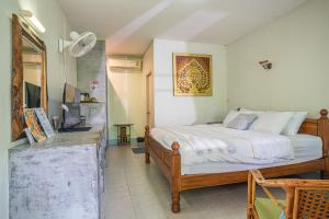 a bedroom with a bed and a television in it at The Houme - Fisherman Village in Bophut