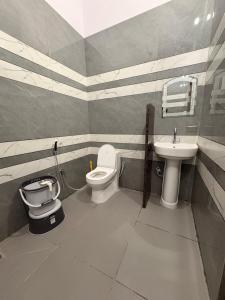 a bathroom with a toilet and a sink at MShotel Surajgarh in Sūrajgarh