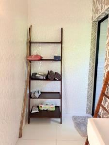 a shelf in a bathroom next to a wall at Alit House in Phra Nakhon Si Ayutthaya