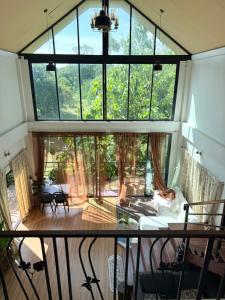 a view of a living room with a large window at Alit House in Phra Nakhon Si Ayutthaya
