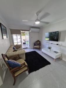 a living room with a couch and a table at Avocet Apartment in Perth