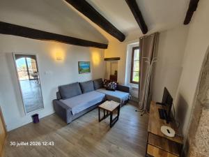 a living room with a couch and a table at Villa Arca in Les Arcs sur Argens