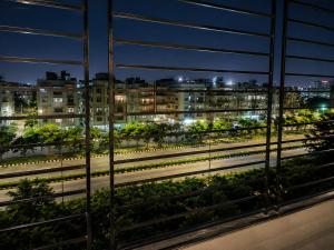 a view of a city at night from a window at Flying Suites Newtown in kolkata