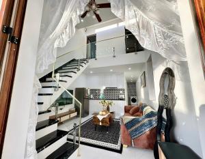 a living room with a staircase in a house at ROSE HOUSE Cat Ba island in Cat Ba