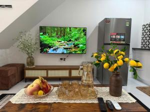 a living room with a table with fruit on it at ROSE HOUSE Cat Ba island in Cat Ba