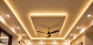 a coffered ceiling with a ceiling fan in a room at Flying Suites Newtown in kolkata