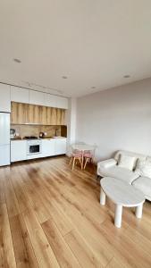 a living room with a couch and a table at 21 floor apartment in Tbilisi City