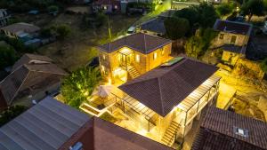 an overhead view of a house with lights at Dervisia Stonehouse 4 in Lazaráta