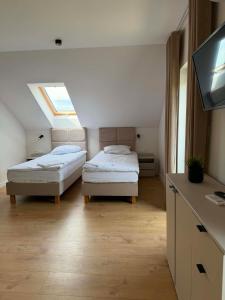 two beds in a room with a skylight at Widokówka Radostowa in Podmąchocice +45 photos