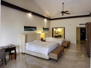 
a hotel room with a bed and a television at Casa Colonial Beach & Spa in San Felipe de Puerto Plata
