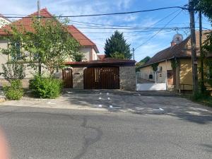 a garage with a wooden door in a house at Hello Apartman in Budaörs