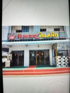 a building with a library island sign on it at YVs Hungry island in Bāpatla