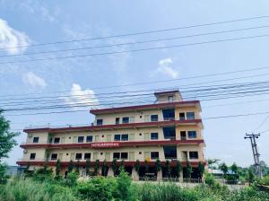 a large building with a lot of windows on it at Hotel Buddha Palace in Rummindei