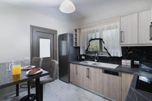 a kitchen with a table with a plate of food on it at Athena Villas in Vasilikos