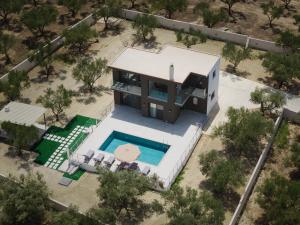 an overhead view of a house with a swimming pool at Athena Villas in Vasilikos