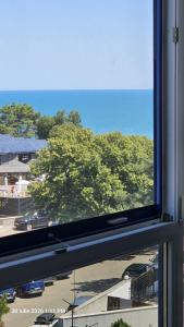 a window with a view of a parking lot at Sea View Ani in Olimp