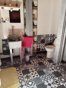 a bathroom with a sink and a toilet at Le repaire des écureuils in Bourg-Argental