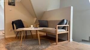 a living room with a couch and a table at Hello Apartman in Budaörs