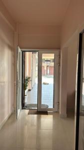 an empty hallway with a sliding glass door to a patio at Serenity View Stay in Shillong