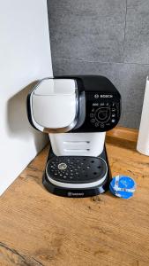 a coffee maker sitting on top of a wooden table at Moderne liebevolle Ferienwohnung in Bergkamen