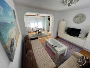 a living room with a couch and a table at Restful Garden Apartmants in Sarajevo