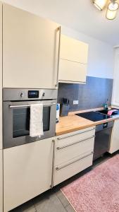 a kitchen with a stainless steel oven and a sink at Moderne liebevolle Ferienwohnung in Bergkamen