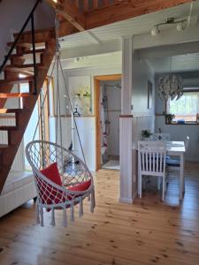 a swing in a room with a table and a staircase at Villa Aili in Pärnu