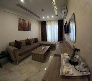 a living room with a couch and a table at Antalya Hotel Am in Amman +22 photos