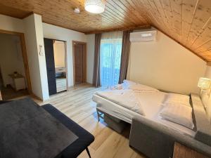 a bedroom with a bed and a couch in it at Haus Seerose in Seeboden