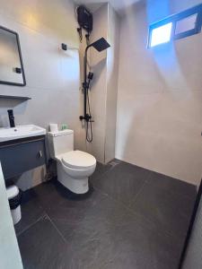 a bathroom with a white toilet and a sink at Lunan Boutique Hotel & Hostel in Taytay