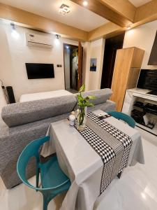 a living room with a table and a couch at Lunan Boutique Hotel & Hostel in Taytay