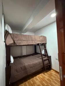 a bunk bed in a room with a ceiling at La Casita de Merme in Oxapampa +10 photos