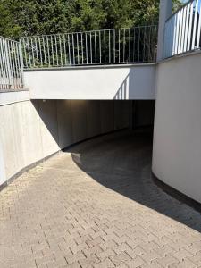a building with a walkway with a balcony on top at Comfort Apartment in Lörrach