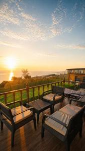a group of chairs and tables on a deck with the sunset at Galaxy Bungalow in Trabzon