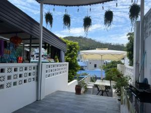 a patio with an umbrella and a table and chairs at ROSE HOUSE Cat Ba island in Cat Ba