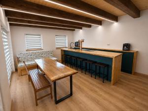 a kitchen with a wooden table and a counter top at Wellness chalupa in Havlíčkŭv Brod