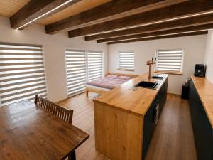 a kitchen with a wooden island in a room at Wellness chalupa in Havlíčkŭv Brod +4 photos
