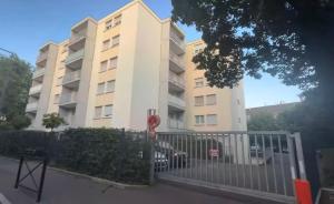 an apartment building with a fence in front of it at Blāck diamond spa in Mulhouse