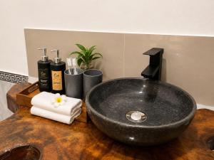 a bathroom with a black sink on a wooden table at Tegal Luwih Cabin in Munduk +29 photos