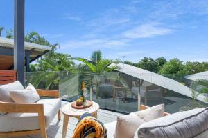 a patio with white furniture on a balcony at Jila Cable Beach in Cable Beach